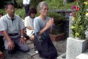 Japanese woman from N. Korea prays at family grave